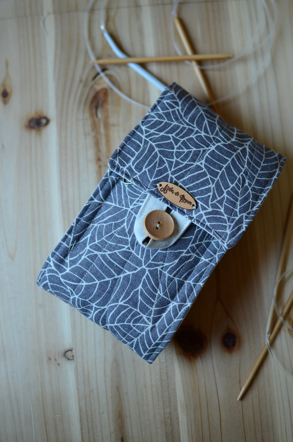 Circular knitting needle organizer with many pockets and notion pouch for lots of needle sets