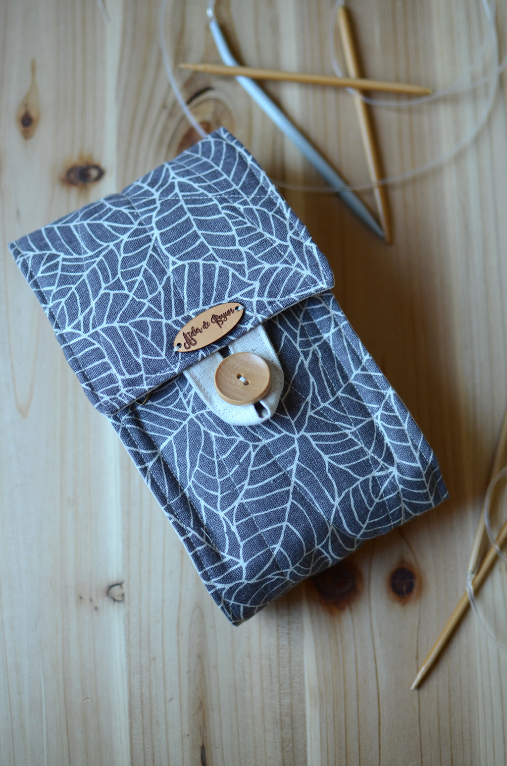 Circular knitting needle organizer with many pockets and notion pouch for lots of needle sets