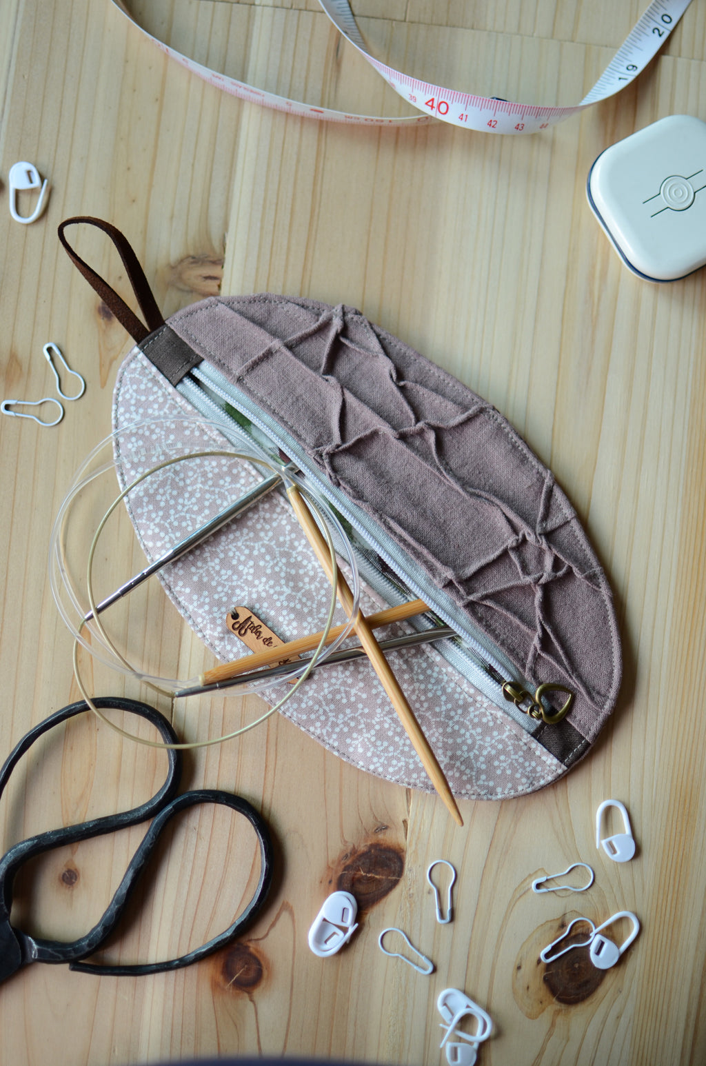 Unique knitting needle organizer for knitting needles, stitch markers, tape measure, and scissors