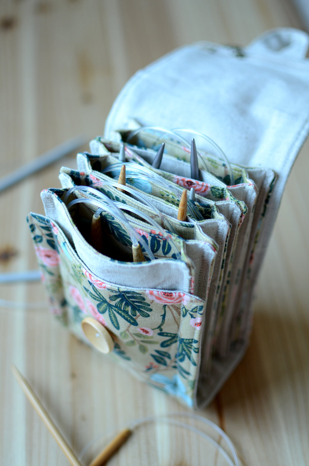 Circular knitting needle storage in mustard flower with many pockets and zipper notion pocket