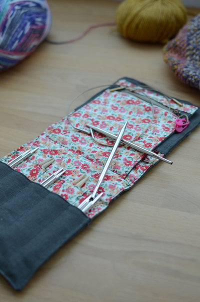 Travel knitting needle holder that carries all your knit necessities and more. Perfect summer vacation knitting bag.
