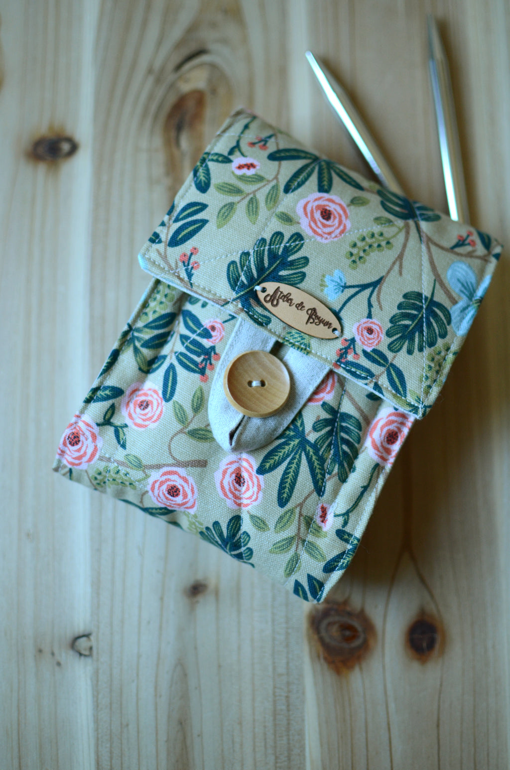 Interchangeable knitting needle storage with a zipper pocket